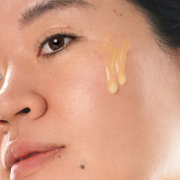 clinical resolution age defying liposomal retinol 1% pure retinol serum smear on face of woman