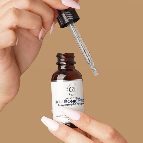 CRL Hyaluronic Peptide Serum in hand with beige background