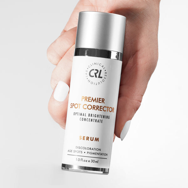clinical resolution premier spot corrector serum in hand white background