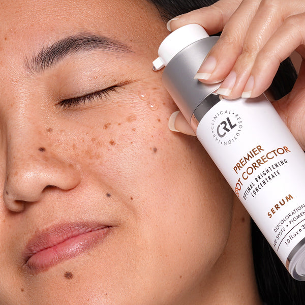 clinical resolution premier spot corrector serum with model, serum on cheek