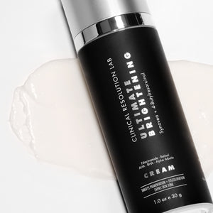 ultimate brightening cream on top of smear on white background