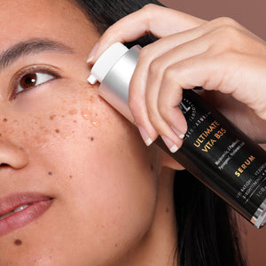 clinical resolution ultimate vita b35 bottle in hand of model with serum on face