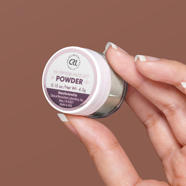 VX Peptide Face Lift powder in hand on brown background