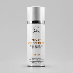 clinical resolution premier spot corrector serum in white bottle on gray background