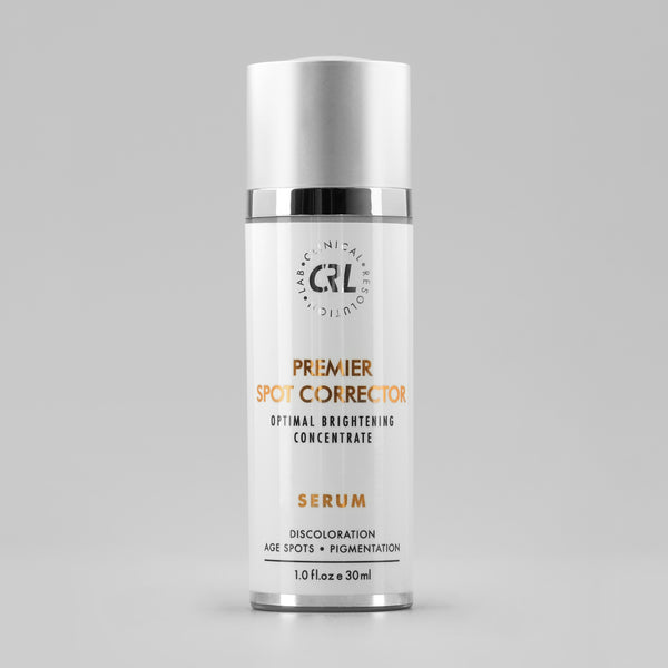 clinical resolution premier spot corrector serum in white bottle on gray background