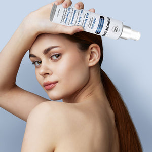 a model with a bottle of ExoSpicule Toner