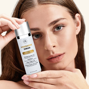 a model with a bottle of Vitathione Serum