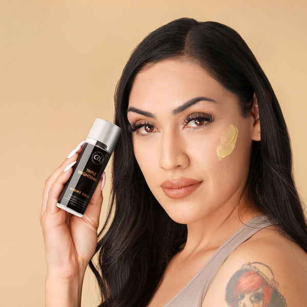 Woman holding a skincare product with a beige background
